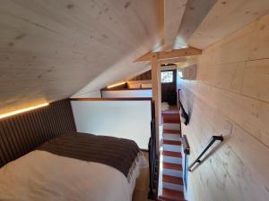 a small bedroom with a bed in a tiny house at Tiny House Annecy in Annecy +6 photos