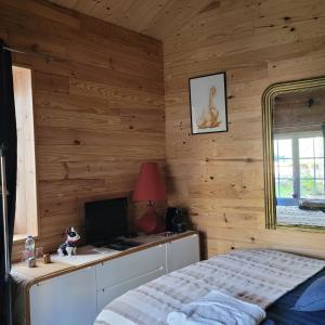 a bedroom with a bed and a desk with a computer at La Lézardière in Saint-Germain-sur-École