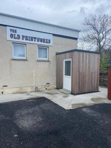 a building with a door and a sign on it at The Old Printworks, Kirkwall in Orkney