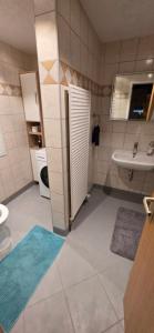 a bathroom with a sink and a toilet and a sink at Ferienwohnung in der Altstadt,3 in Annaberg-Buchholz +5 photos