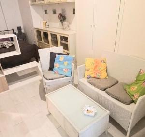 a living room with two chairs and a coffee table at Un Raggio di Sole - a due passi dal mare in Montesilvano +14 photos