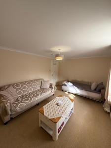 a living room with a couch and a table at Culloden Stables 4 in Inverness