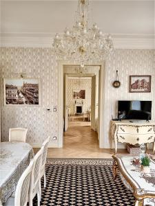 a room with a bed and a chandelier at Apartment Luxury Nostalgia in Karlovy Vary