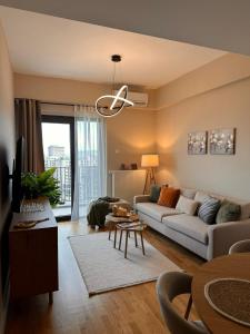 a living room with a couch and a table at EVA Premium Luxury Apartments - Limak Diamond Residence in Skopje