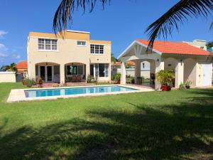 a house with a swimming pool in front of it at A Private Paradise by the Rainforest in Luquillo