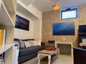a living room with a couch and a fireplace at La Casa di Ornella in Rome +34 photos