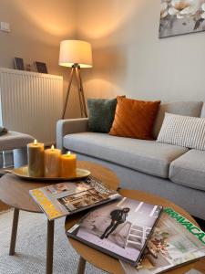 a living room with a couch and a coffee table at EVA Premium Luxury Apartments - Limak Diamond Residence in Skopje