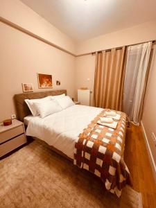 a bedroom with a bed with a blanket on it at EVA Premium Luxury Apartments - Limak Diamond Residence in Skopje