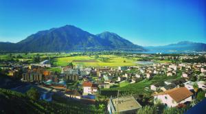 an aerial view of a city with mountains in the background at Ca Mea - Lake View, Parking, EV in Gordola