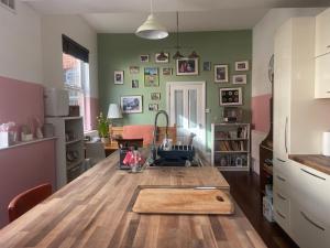 a kitchen with a table with a cutting board on it at Trailside in Headingley in Leeds
