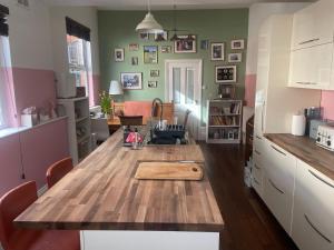 a kitchen with a wooden table in a room at Trailside in Headingley in Leeds +12 photos