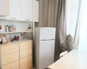 a kitchen with a white refrigerator and a white cabinets at Un Raggio di Sole - a due passi dal mare in Montesilvano