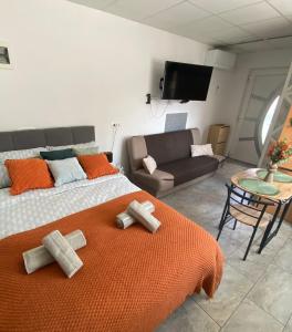 a bedroom with a large bed with an orange blanket at Studio Angelina in Prestranek