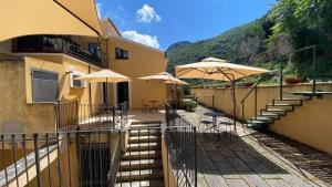 a building with umbrellas and tables and chairs at Suite Casa Santicelli Maratea in Maratea