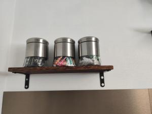 a shelf with three cups on a wall at Charmant Studio indépendant in Louvres