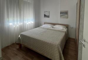 a bedroom with a bed and a window at Rezidenca Kalter Durres in Golem +31 photos
