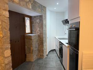 a kitchen with a stone wall and a counter top at Mabel House Suites in Mijares