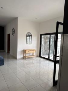 a living room with a table and a large window at Chez Sira in Warang