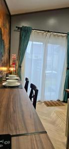 a dining room table with chairs and a large window at The NOOK in Kinlochleven +12 photos