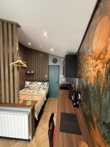 a bedroom with a bed and a large painting on the wall at The NOOK in Kinlochleven