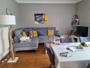 a living room with a couch and a table at L'Ourson in Colmar