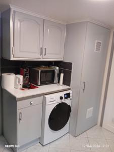 a kitchen with a microwave and a dishwasher at Large Studio in a cozy house in Ormesson-sur-Marne +12 photos