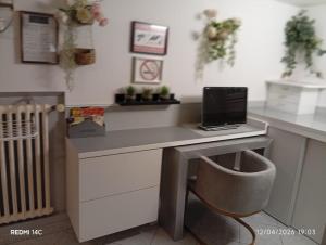 a desk with a laptop computer on top of it at Large Studio in a cozy house in Ormesson-sur-Marne