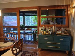 a kitchen with a dresser with bottles of wine at Refúgio da Serra in Campos do Jordão