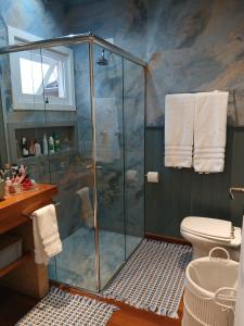 a bathroom with a shower and a toilet at Refúgio da Serra in Campos do Jordão +42 photos