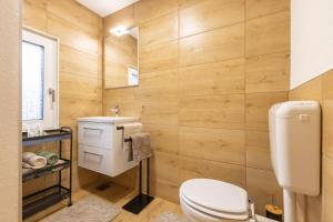 a bathroom with a toilet and a sink at Srčkova Koča in Kočevje