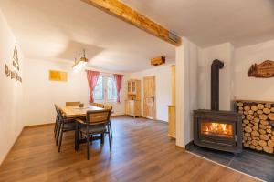 a dining room with a table and a fireplace at Srčkova Koča in Kočevje