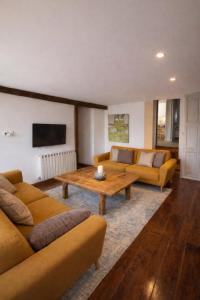 a living room with two couches and a coffee table at Casa en Vilallobent Cerdanya ideal familias by CalQuerol in Vilallovent