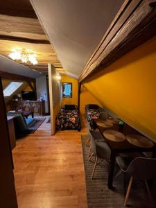 a room with tables and chairs and a couch at Šumava apartmán U Kočiček in Strašice