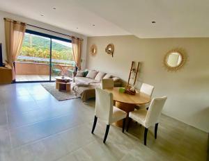 a living room with a table and a couch at Résidence Petru-Maria in Propriano
