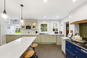 a kitchen with white cabinets and a white counter top at Lee's Historic Mansion in Cheshunt