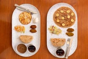 two plates of food on a wooden table at Dahab Hostel in Cairo +39 photos