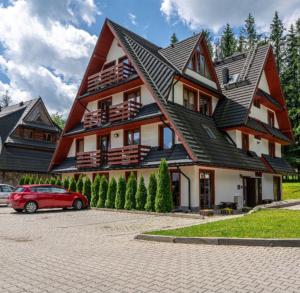 a house with a red car parked in front of it at U Efci in Kościelisko