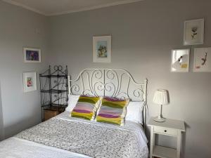 a bedroom with a white bed with a white bedspread at El Olivo de Sansol in Sansol +11 photos