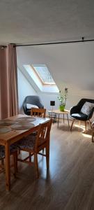 a living room with a table and chairs and a skylight at Agroturystyka pod kasztanem in Lutowiska