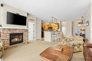 a living room with a fireplace and a tv at Bird's Eye View at Hawk's Eye in Bellaire