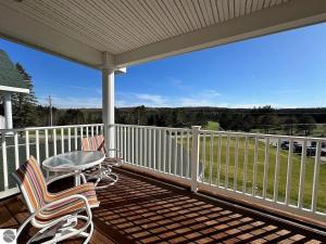 a porch with two chairs and a table on it at Bird's Eye View at Hawk's Eye in Bellaire