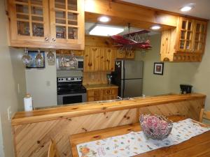 a kitchen with wooden cabinets and a counter top at No Worries at Summit Village! in Bellaire