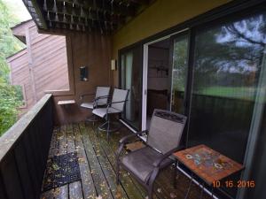 a screened in porch with chairs and a table at No Worries at Summit Village! in Bellaire