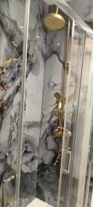 a bathroom with a marble wall and a shower at Mabel House Sierra de Gredos in Mijares +20 photos