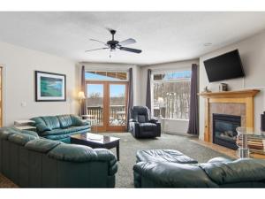 a living room with two couches and a fireplace at Skier's Slopeside Haven in Bellaire