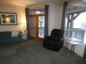 a living room with a couch and a chair at Skier's Slopeside Haven in Bellaire