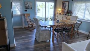 a dining room with a wooden table and chairs at Sunset View Centennial Farm in Mancelona