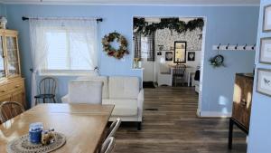 a living room with a table and a couch at Sunset View Centennial Farm in Mancelona