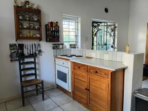 a kitchen with a stove and a white refrigerator at Natalie's Garden Cottage, in McGregor