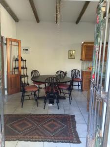 a dining room with a table and chairs at Natalie's Garden Cottage, in McGregor